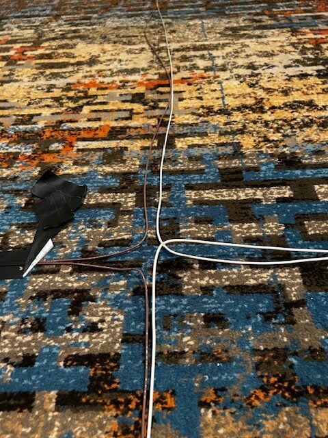 Tape is pull back: wire on carpet for phased array temporary hearing loop