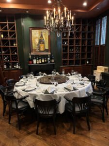 Circular dinner table with place settings and temporary hearing loop