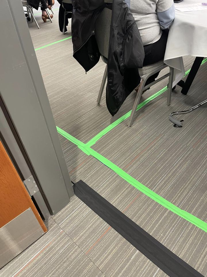 temporary hearing loop with neon green tape on the floor