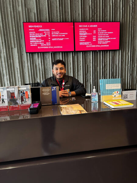 Staff person standing behind the counter hearing loop at the entrance.