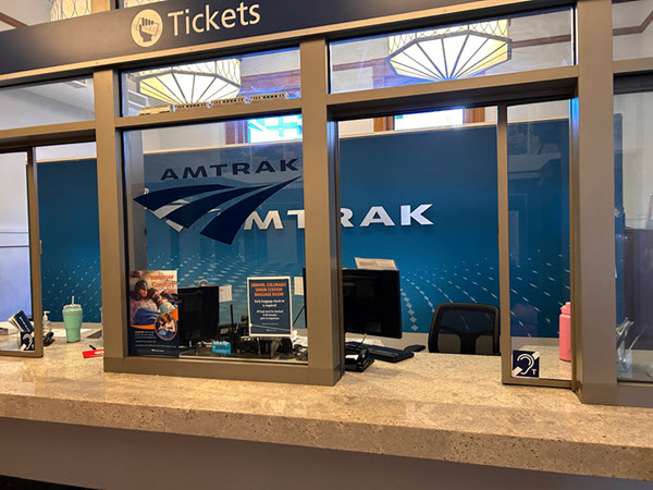 Denver Amtrak ticket counter with two hearing loop signs