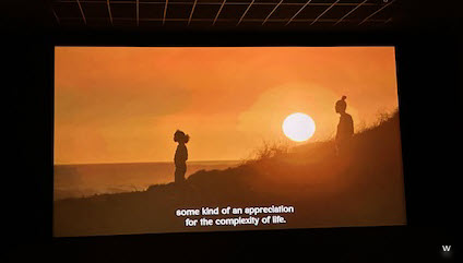 movie theater screen with captions at the bottom of the movie