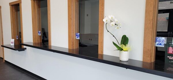 photo of four ticket windows, each with a hearing loop, denoted by a blue sign