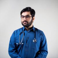 photo of a doctor wearing a blue shirt and a stethoscope around his neck