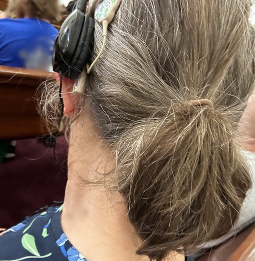 headphone worn on top of cochlear implant processor