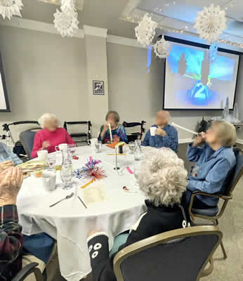 retirement community with people celebrating around a round table